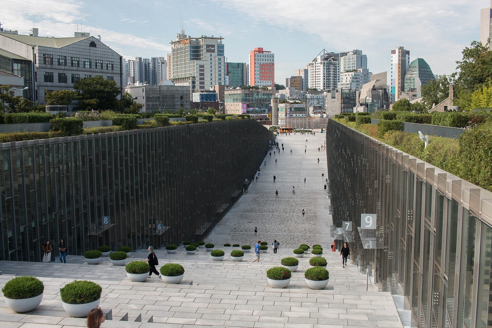The sunken Ewha Campus Complex walkway at Ewha Womans University with the Seoul skyline behind
