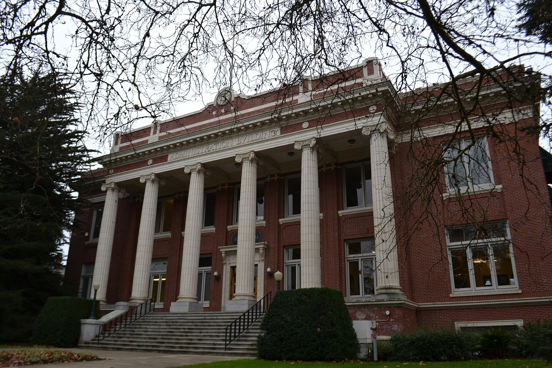 Johnson Hall at the University of Oregon, a red-brick building with a tall white-columned portico