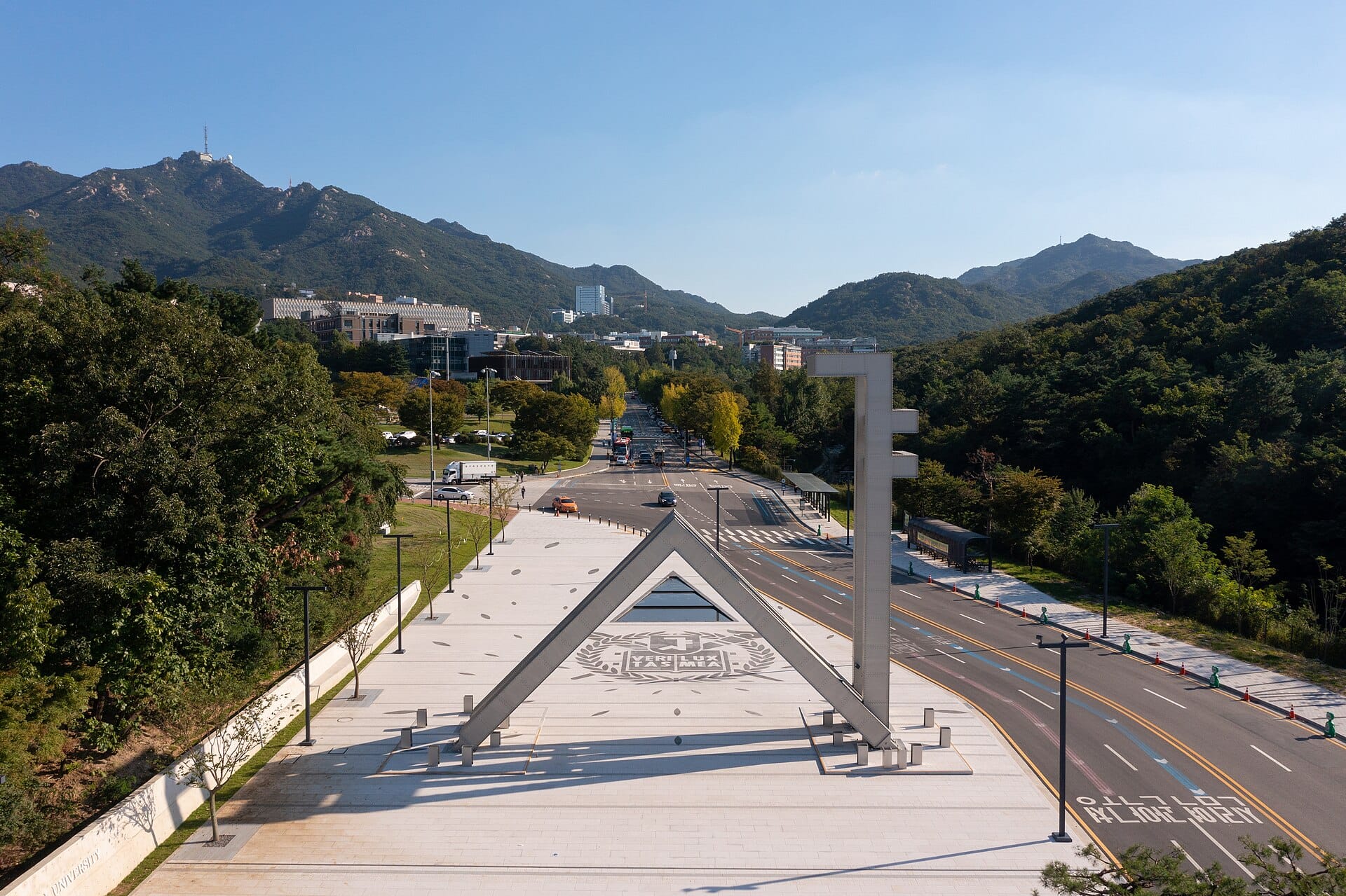 The main gate plaza of Seoul National University with mountains in the background