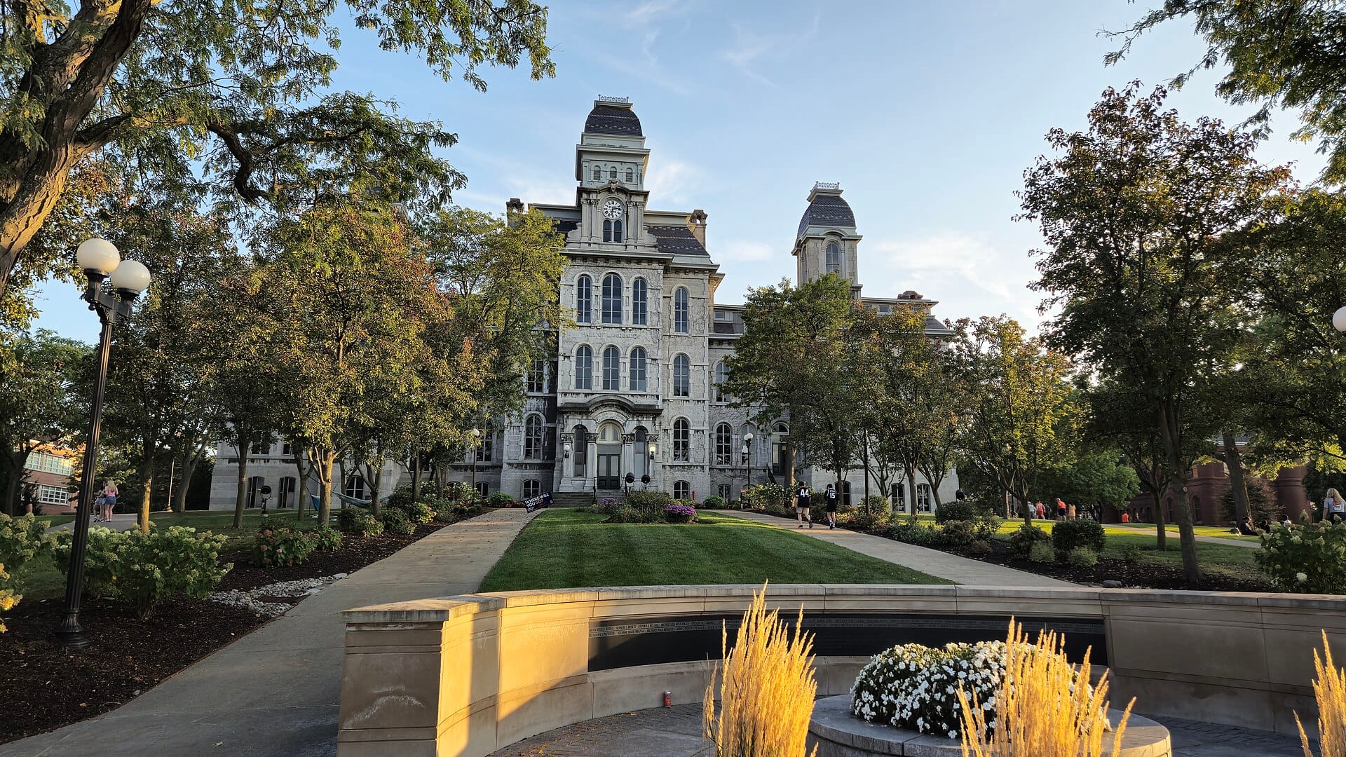 The Hall of Languages at Syracuse University seen across a landscaped lawn on a sunny day